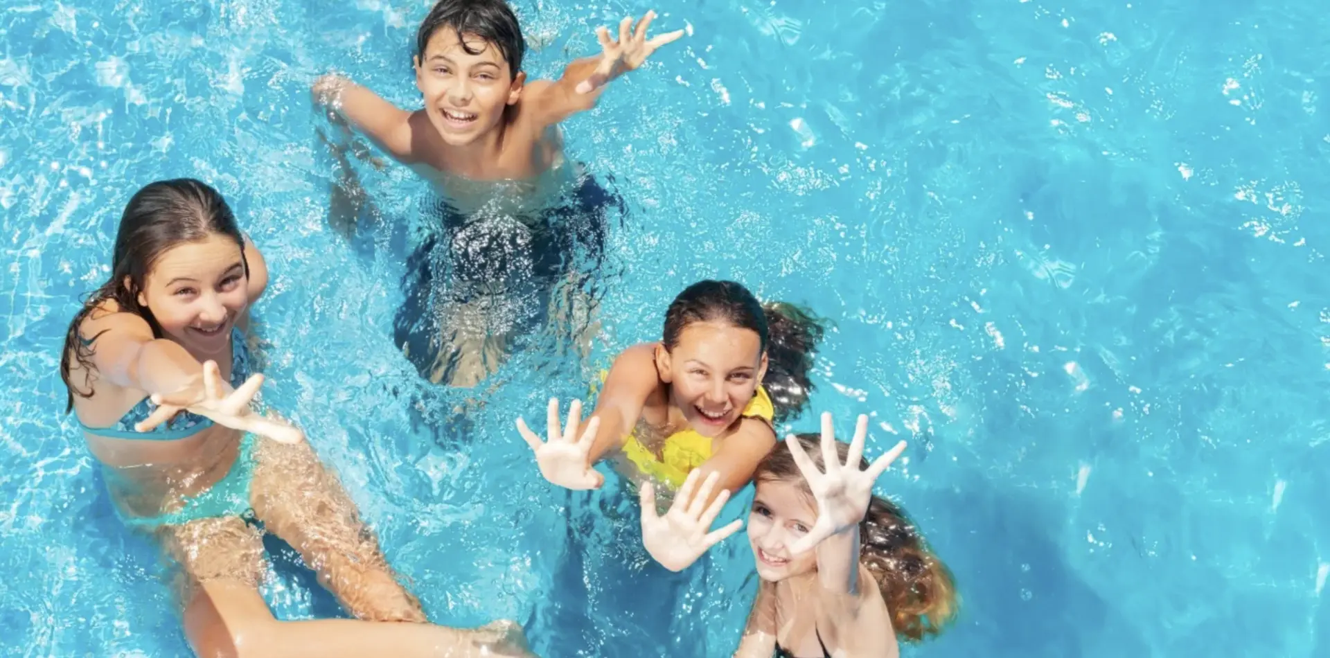 Happy swimmers enjoying a backyard pool